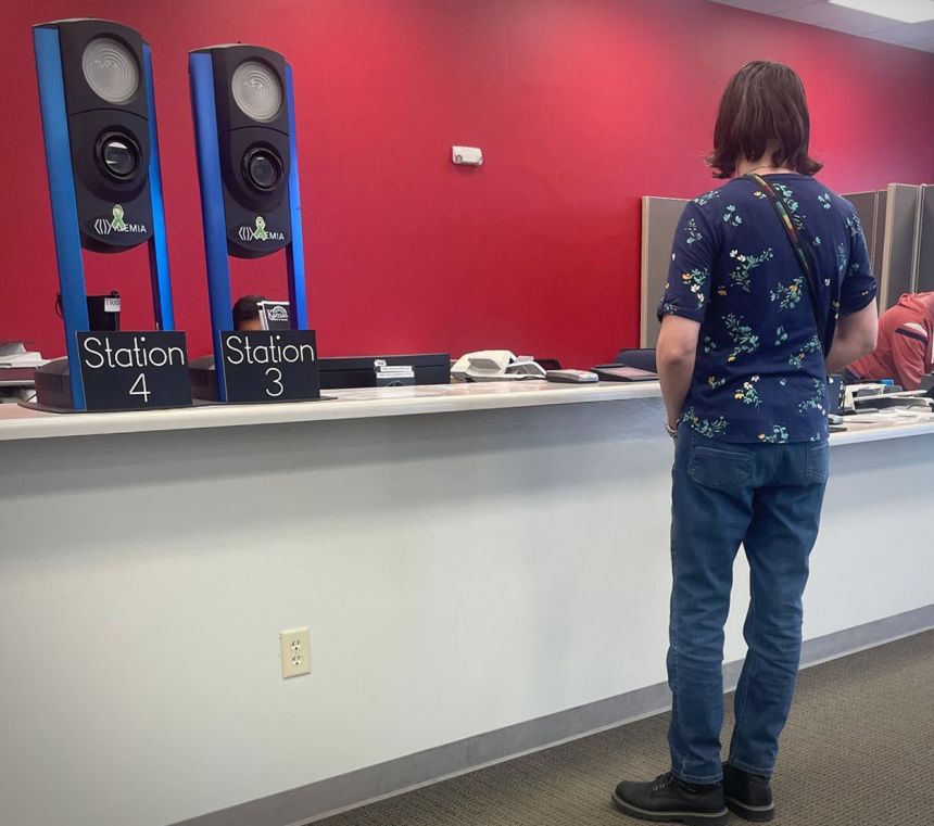 Siobhan Kirchstein stands at a Kansas DMV counter where she surrendered her driver's license on Thursday, February 26.